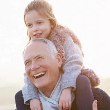 Gentleman with small child on shoulders